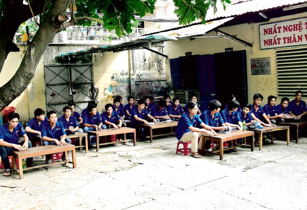 The students gather for a lecture outside and in the warmth of the sun.